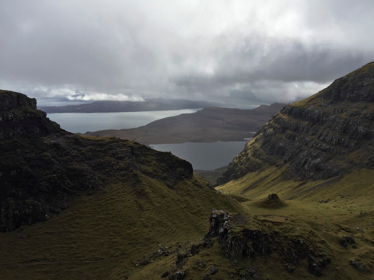 Quiraing amphitheater opening to sea lochs, breaking clouds